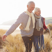 Senior-Couple-Walking-Through-Sand-Dunes-On-Winter-1000