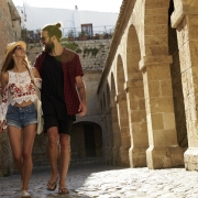 Couple sightseeing in Ibiza, looking at each other